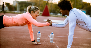 Girl and guy working out together outside 