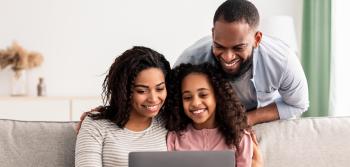 Family in front of a computer