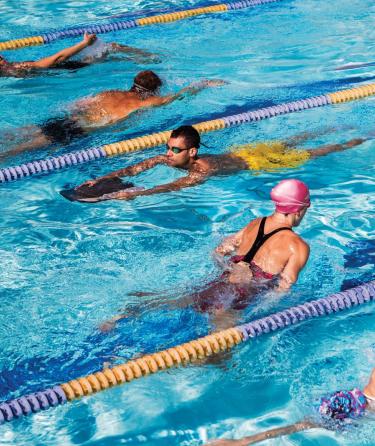 People swimming in a lap pool 