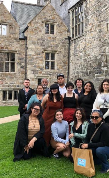 Student and faculty in front of a castle