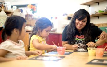 Teacher with 2 children at a table