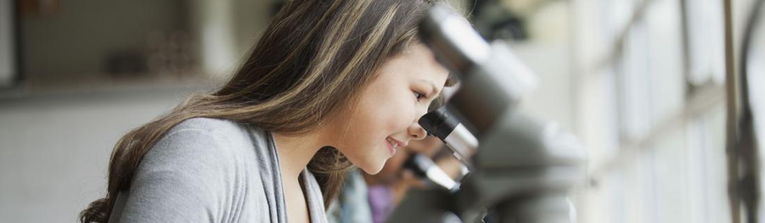 Girl Looking Through a Microscope