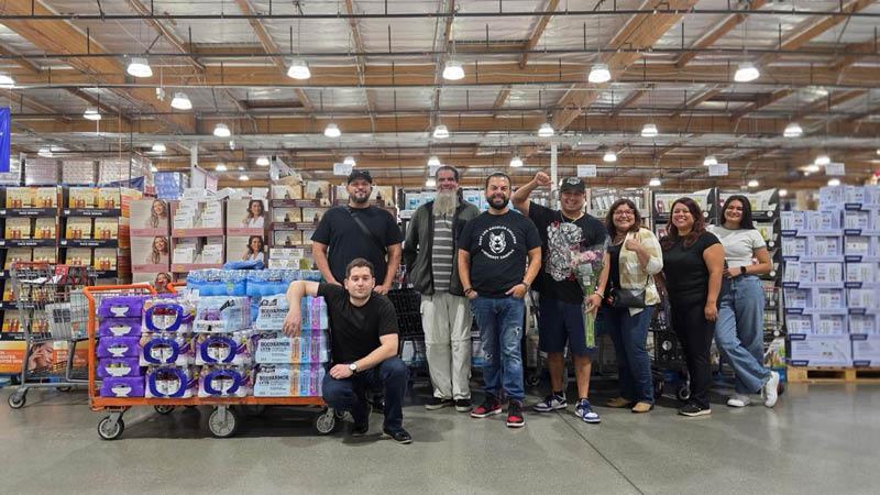 Photo of a group of people standing together inside Costco.