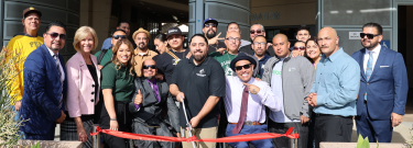 Group of People Cutting a Ribbon