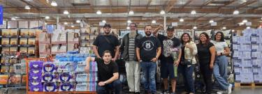 Photo of a group of people standing together inside Costco.