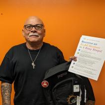 student holding backpack and paper