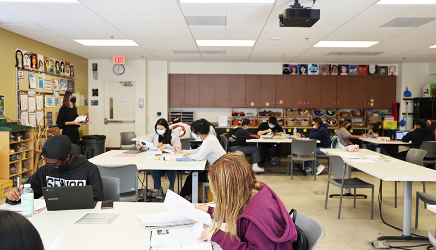 Students Writing Note in Class