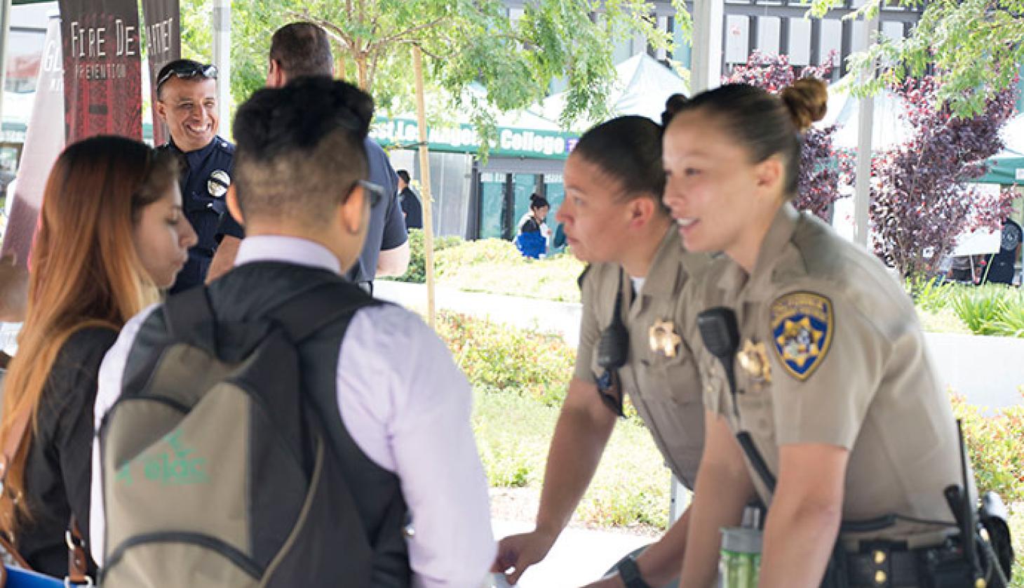 Policewomen in Conversation with Students