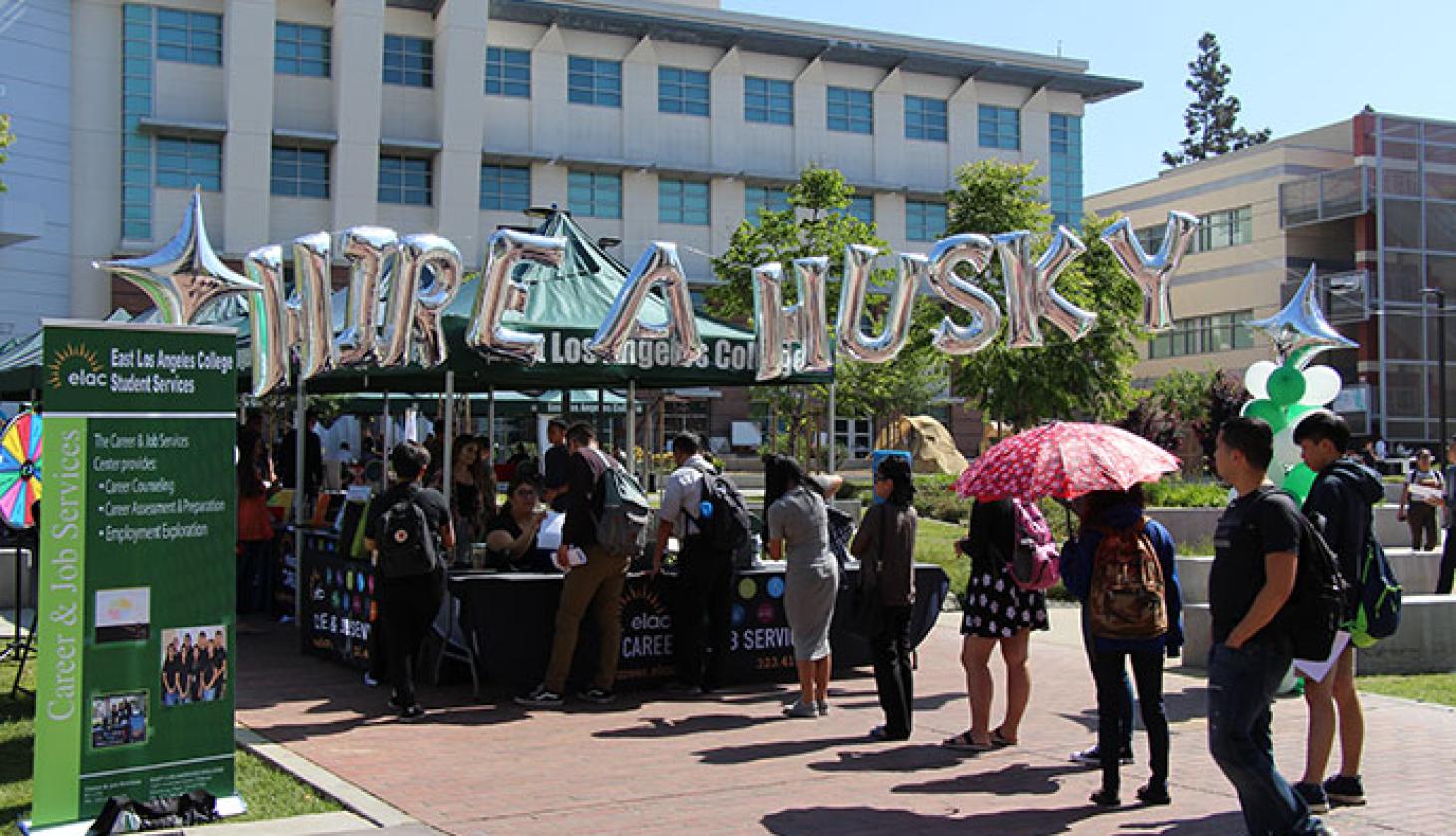 People Lining Up at a Stand